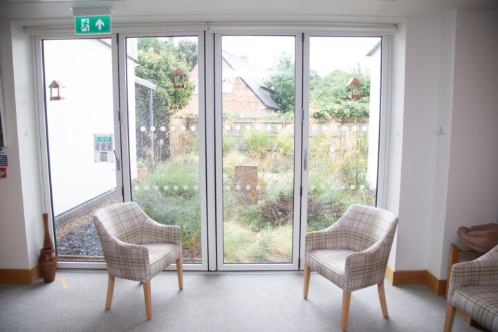 Full length windows, garden and chairs