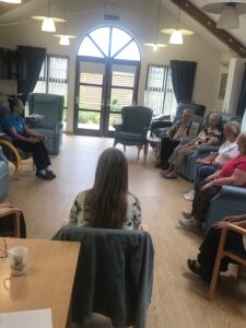 Adults sitting in chairs
