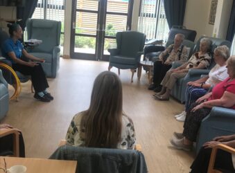 Adults sitting in chairs