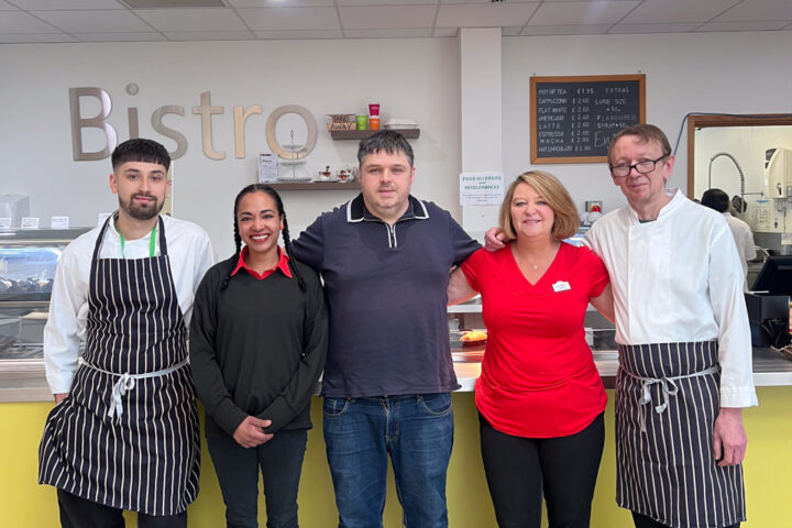 3 males and 2 females standing in a row