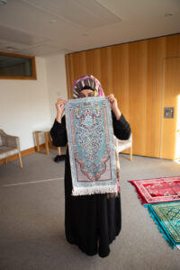Female wearing black dress and scarf