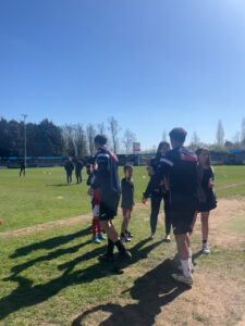 Footballers and mascots on football pitch