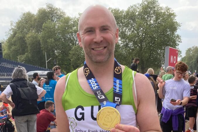 Male holding medal