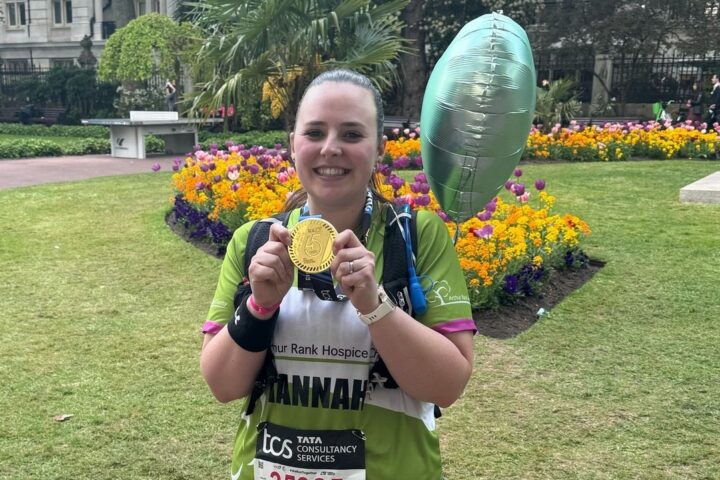 Female holding a medal