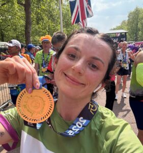 Female holding a medal