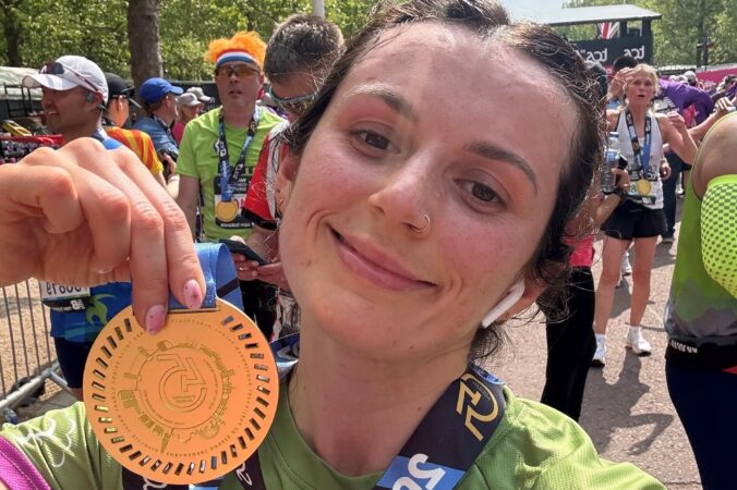 Female holding a medal