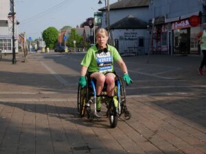 Lady on wheelchair wearing team Arthur tshirt