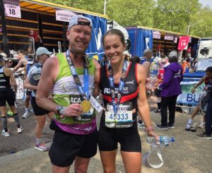 Female and male holding medals