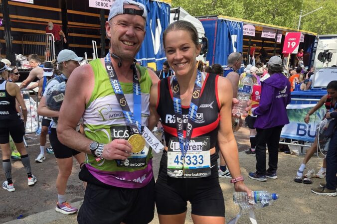 Female and male holding medals