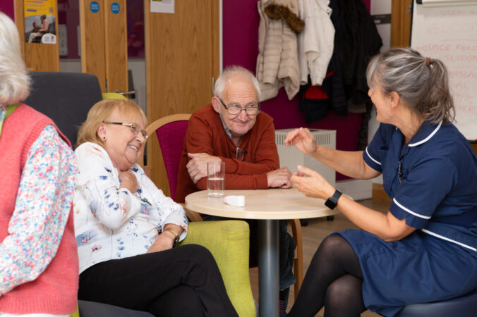 male and female laughing with a nurse