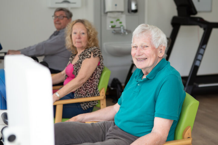 Male sitting in a chair smiling at the camera