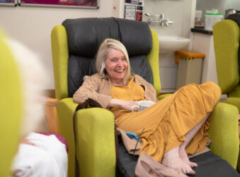 Female sitting in a chair laughing
