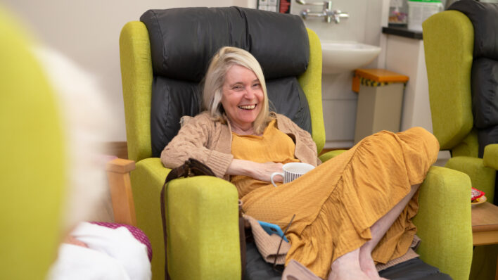 Female sitting in a chair laughing