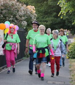 Male and females walkers dressed in green