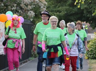 Male and females walkers dressed in green