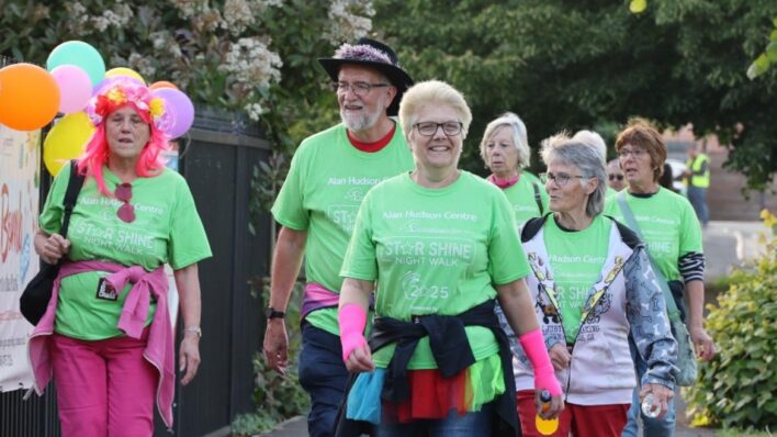 Male and females walkers dressed in green