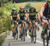 A group of cyclists wearing green tops