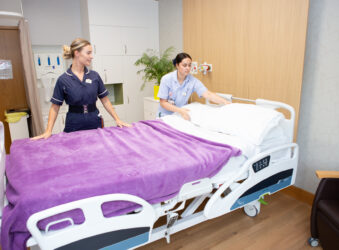 2 nurses making bed