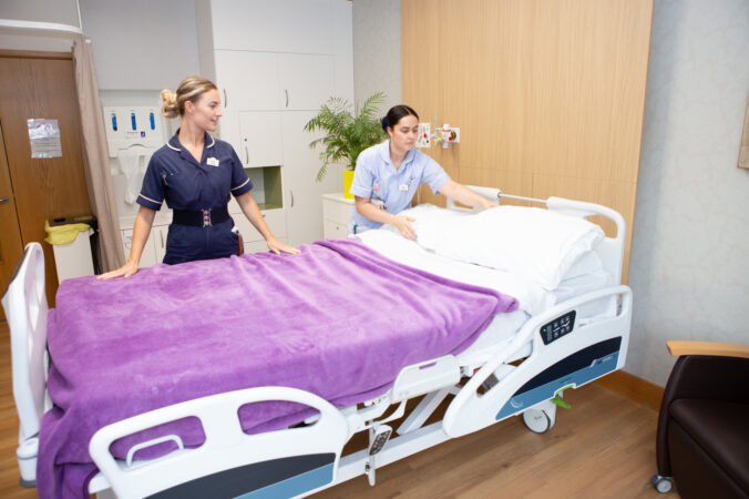 2 nurses making bed