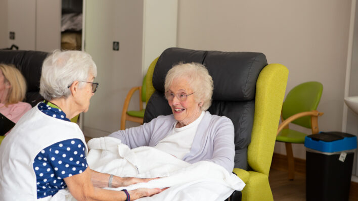 2 females sitting in a chair