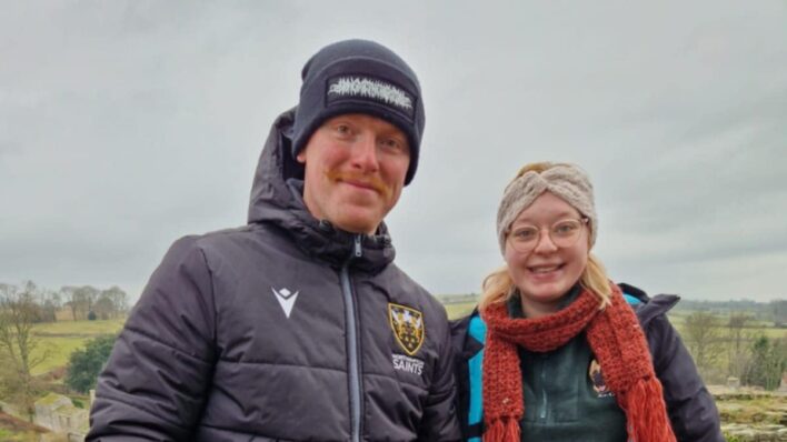 outdoors man and woman with Alsatian