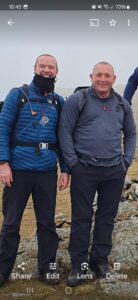 2 males with rucksacks outside 