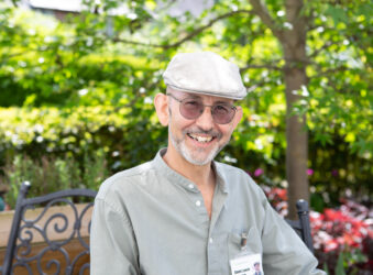 Male wearing a cap outside smiling