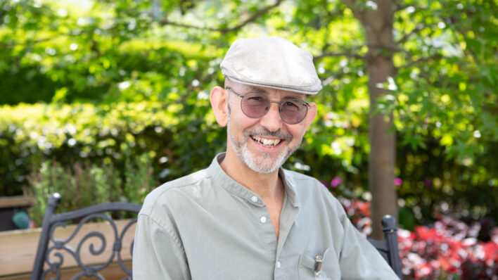 Male wearing a cap outside smiling