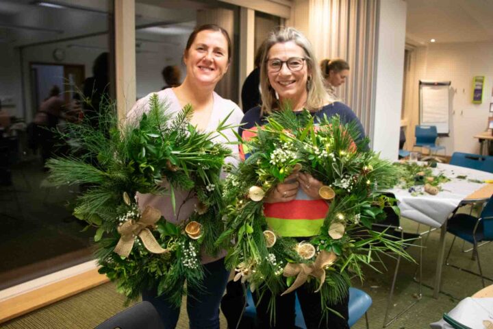 Females holding green wreaths