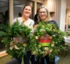Females holding green wreaths