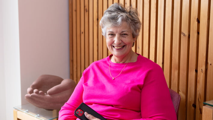 Female wearing pink smiling at the camera