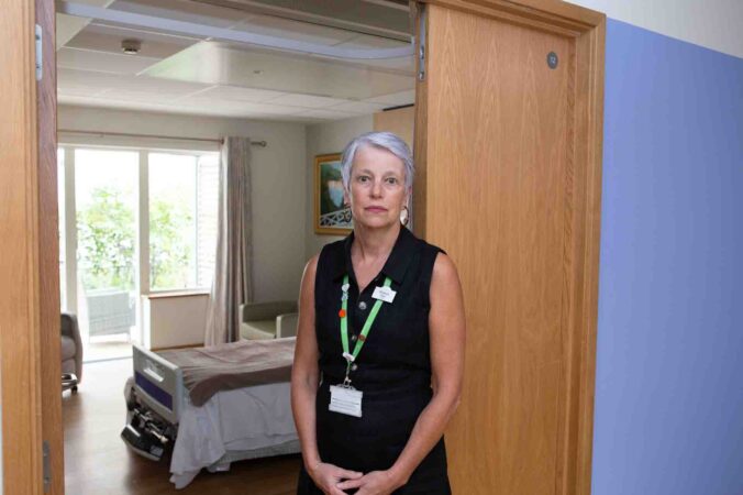 CEO Sharon Allen, stands in front of private room on In-patient Unit