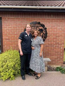 Nurse and female in a garden 
