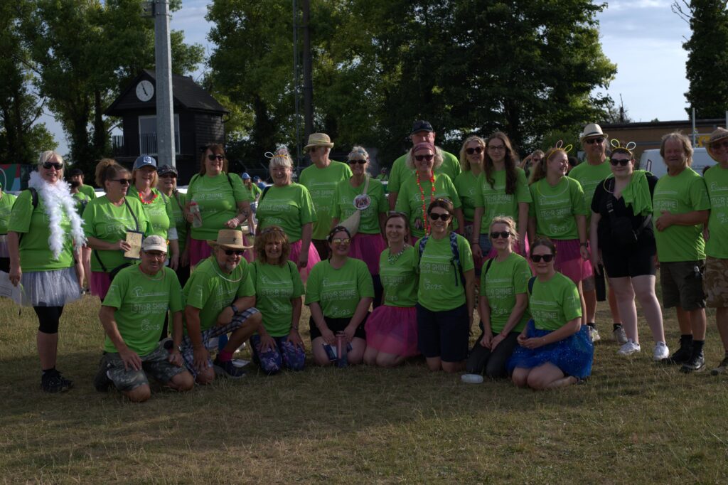 Large group of people posing in their neon green star shine tshirts