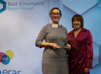 Two females with glass award