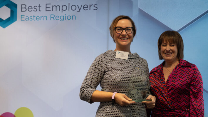 Two females with glass award