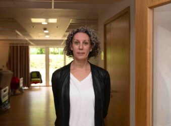 Female near beds in a Hospice Ward