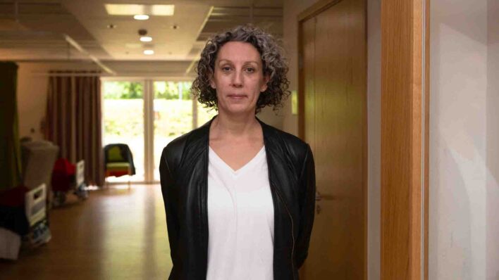 Female near beds in a Hospice Ward