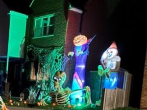 Large coloured toys outside a house in the dark