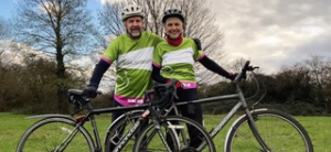 Male and female in green t-shirts and bikes
