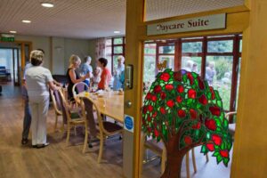 Stained glass window and door open to people in a room