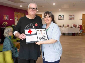 Male and nurse holding a box