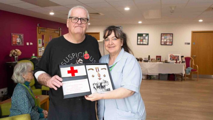 Male and nurse holding a box