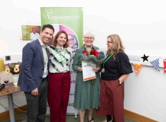 3 females and male with a certificate