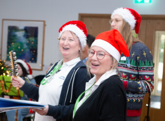 Nurses wearing red santa hats