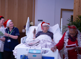 Male in bed with Christmas Hat