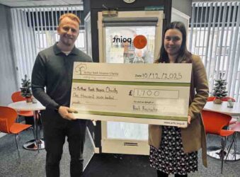 Male and female holding a big cheque