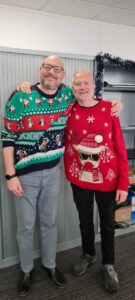 2 males wearing Christmas Jumpers