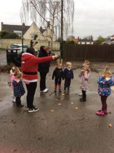 Adult and children wearing reindeer antlers outside