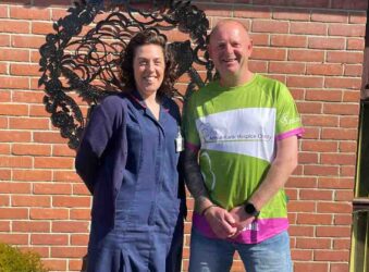 Female nurse and male in green tshirt outside